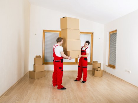 Moving team handling boxes and furniture for a Wandsworth flat move